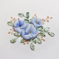 photo de trois fleurs bleues en broderie de ruban