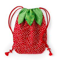 photo d'un sac à dos rouge à poids blanc avec des feuilles décoratives en tissu vert